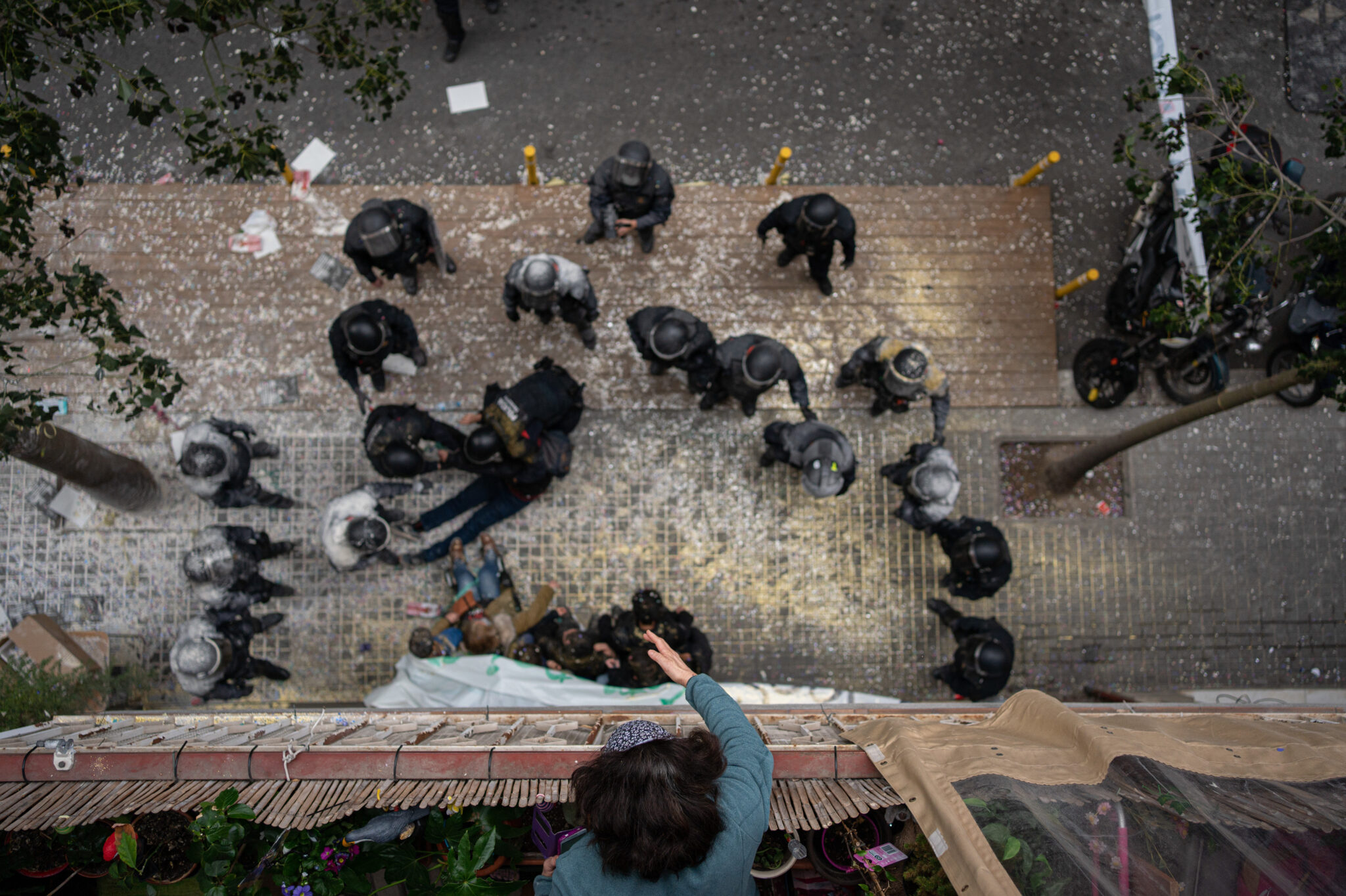 Overhead shot of the Mossos d'Esquadra filled with flour by the people who tried to stop the eviction of a family for non-payment of rent in the Poble-sec neighborhood, on December 14, 2022, in Barcelona (Catalonia).