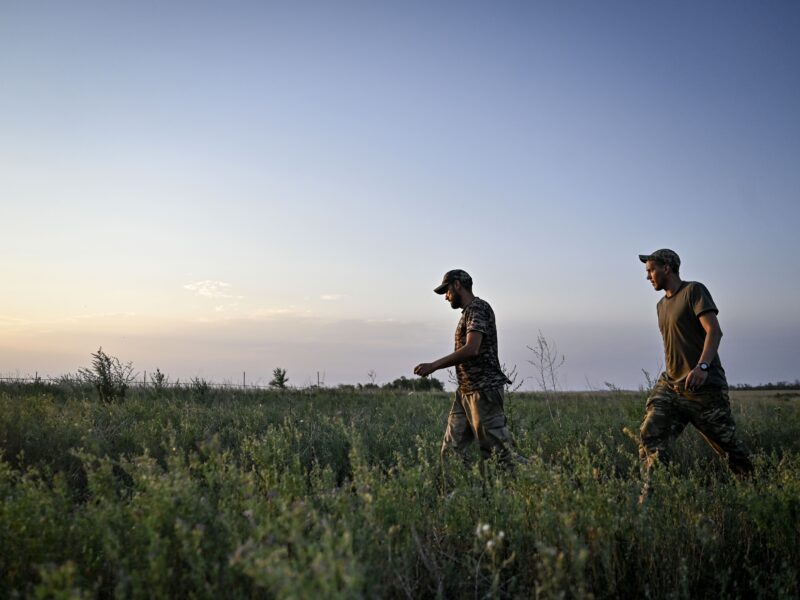 Servicemen walk through a field during a combat mission near Chasiv Yar, Bakhmut district, Donetsk region in eastern Ukraine on July 14, 2024.