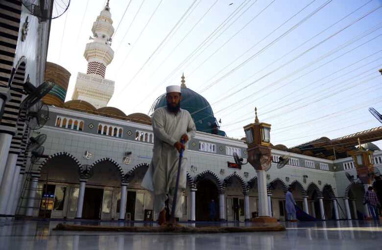 Karachi, Pakistan: A man cleans the floors of Khizra Mosque