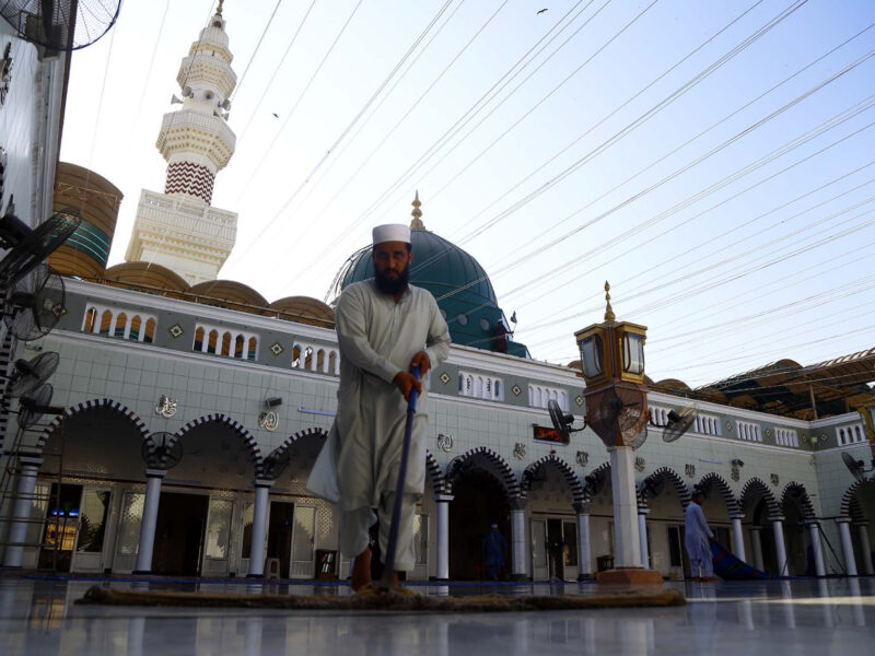 Karachi, Pakistan: A man cleans the floors of Khizra Mosque