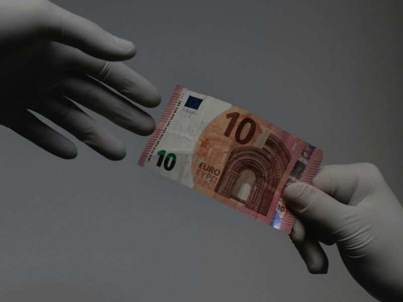 A 10 euro bill being passed.