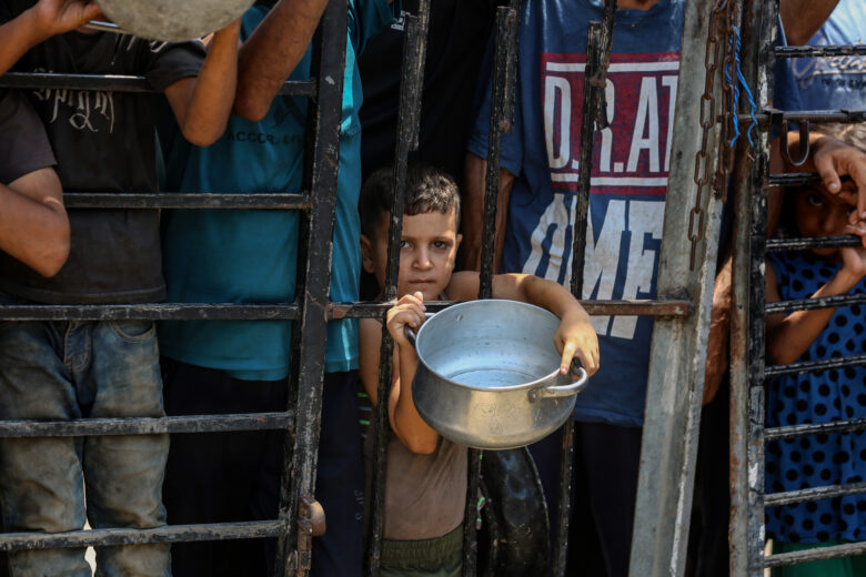 Aug. 11, 2025, Displaced Palestinians wait to get food in the west of Gaza City