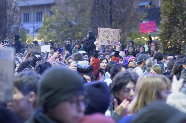 A woman in a crowd in Rome demonstrates holding a sign during the protest against violence against women . November 23, 2024