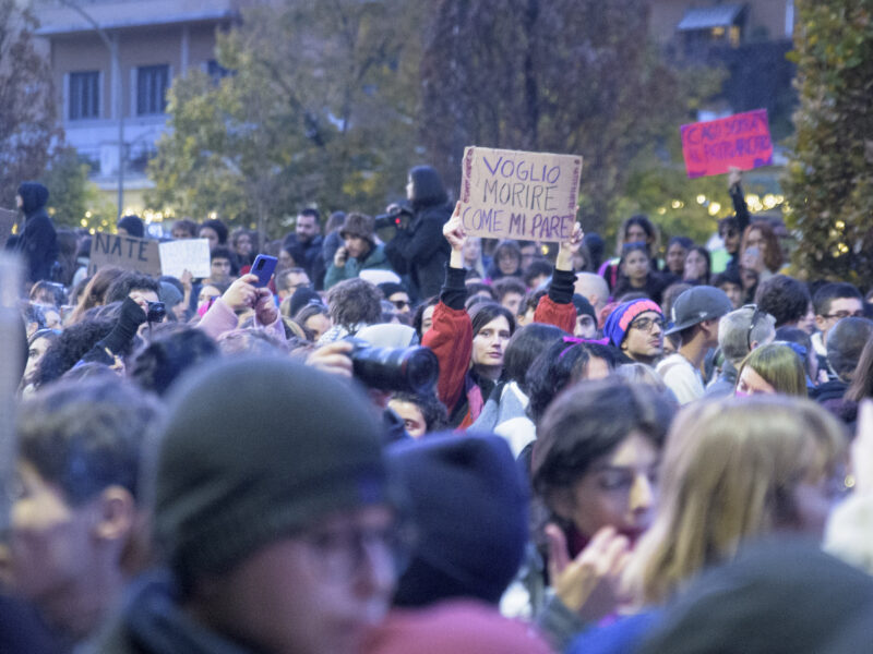 A woman in a crowd in Rome demonstrates holding a sign during the protest against violence against women . November 23, 2024