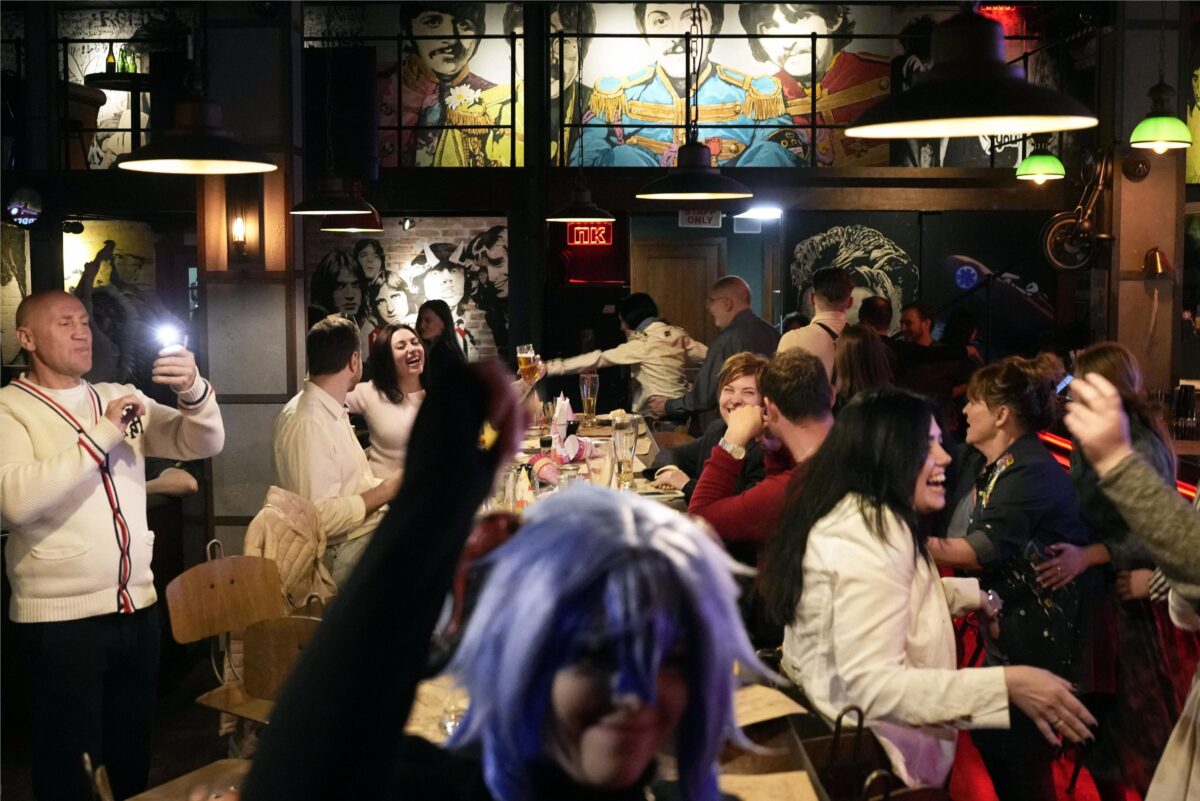 Residents gather inside a bar in Kyiv, Ukraine on March 26, 2023, the day the Ukrainian capital shortened its wartime curfew by an hour to midnight to help businesses.