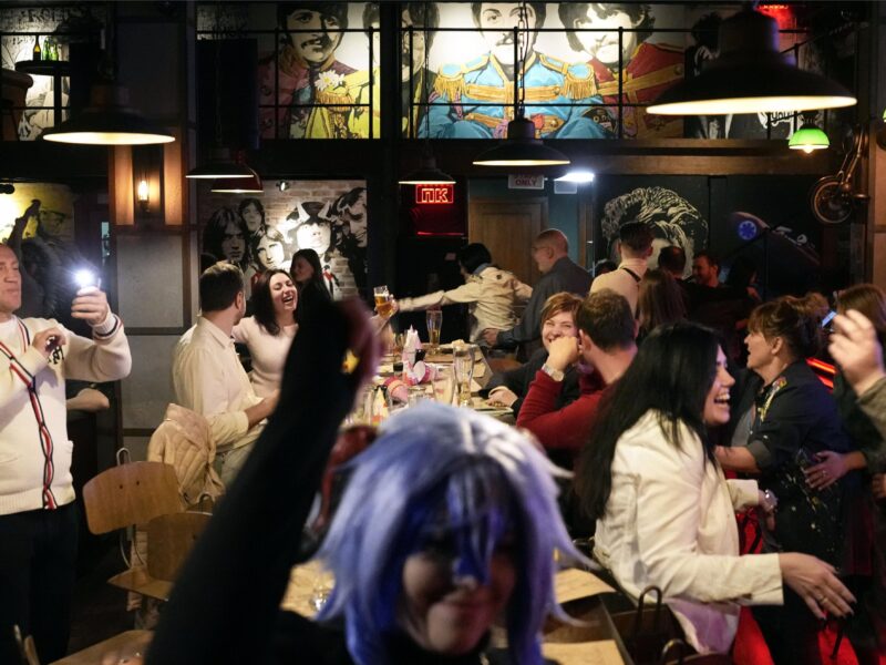 Residents gather inside a bar in Kyiv, Ukraine on March 26, 2023, the day the Ukrainian capital shortened its wartime curfew by an hour to midnight to help businesses.