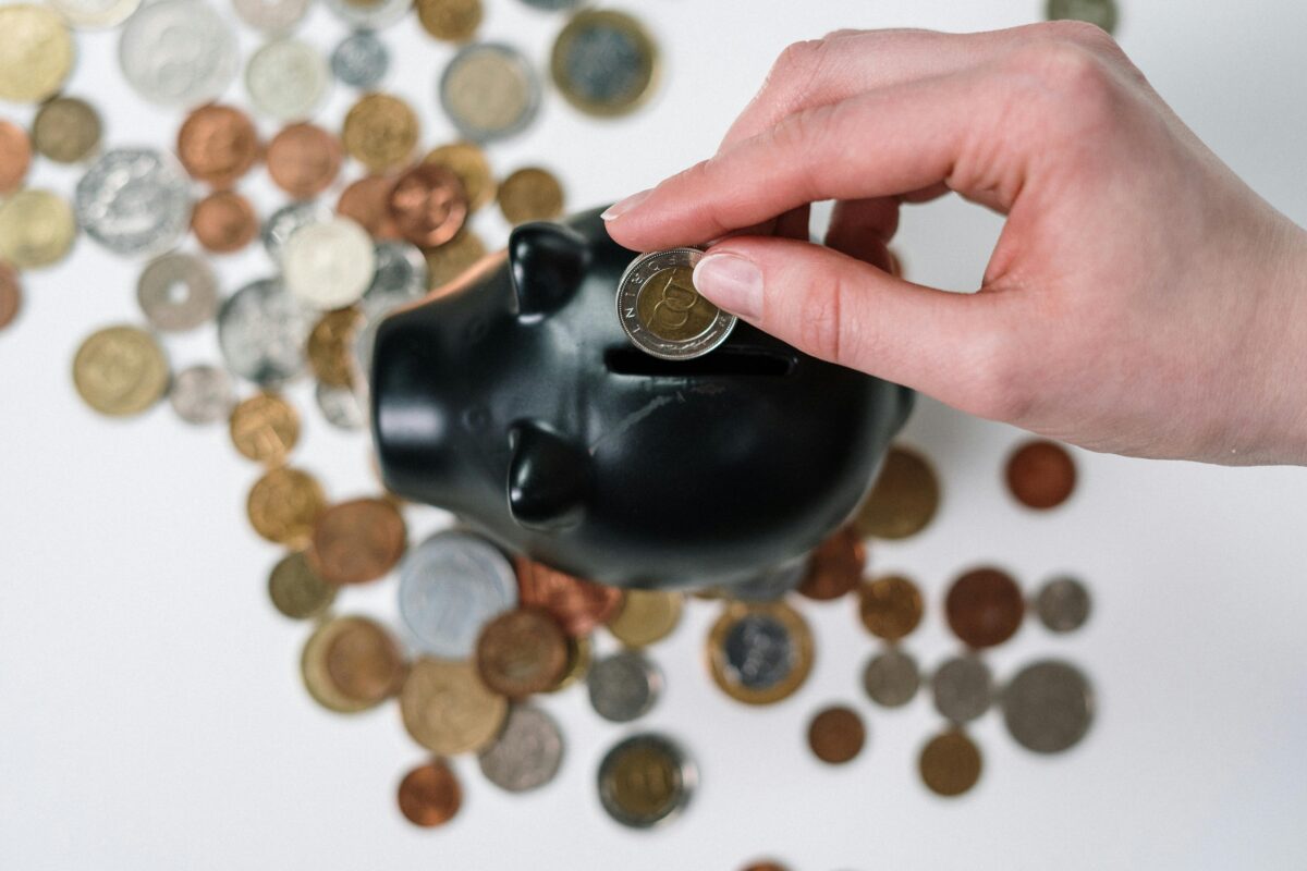 Coins surrounding a piggy bank.