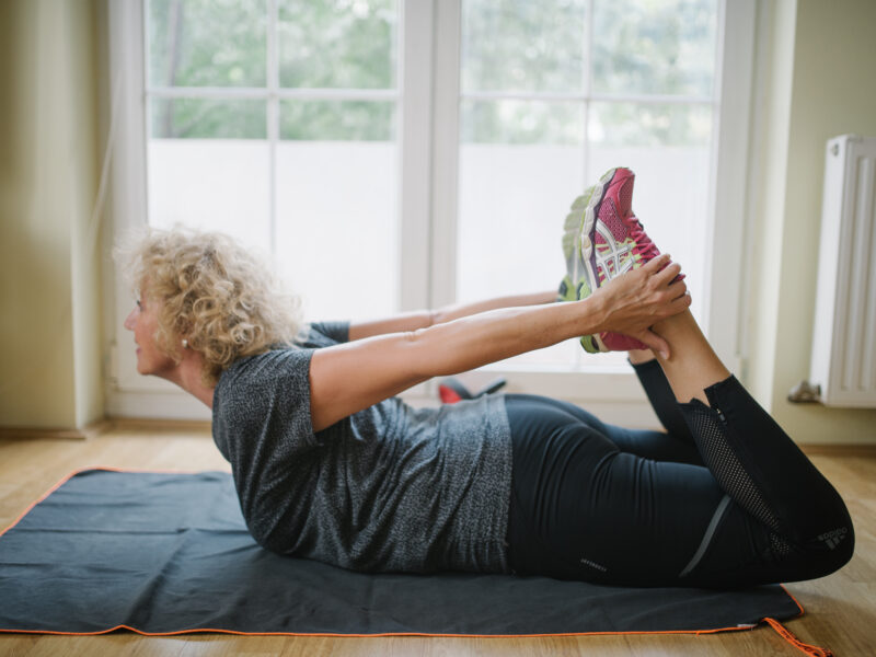Senior woman exercising at home.