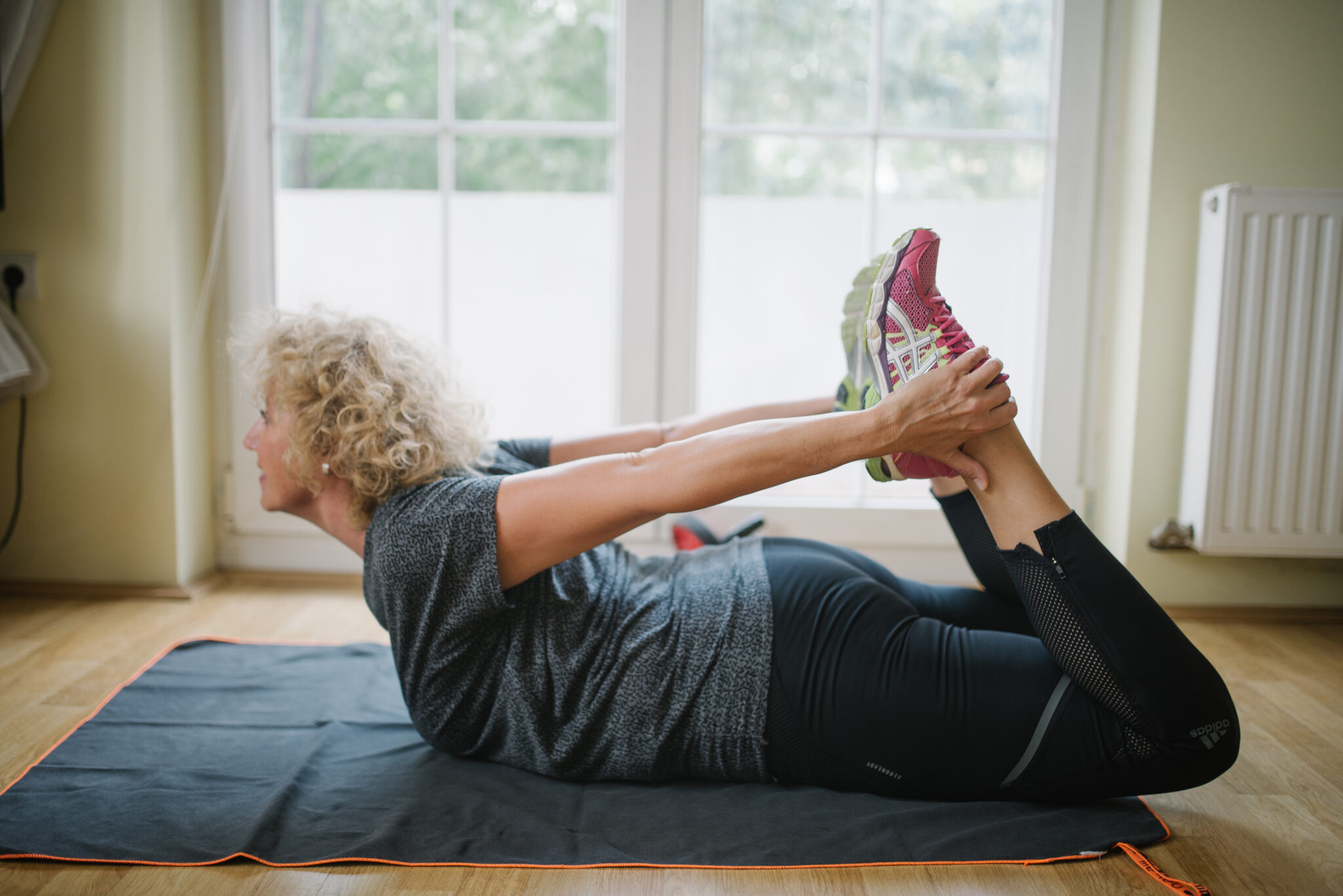 Senior woman exercising at home.