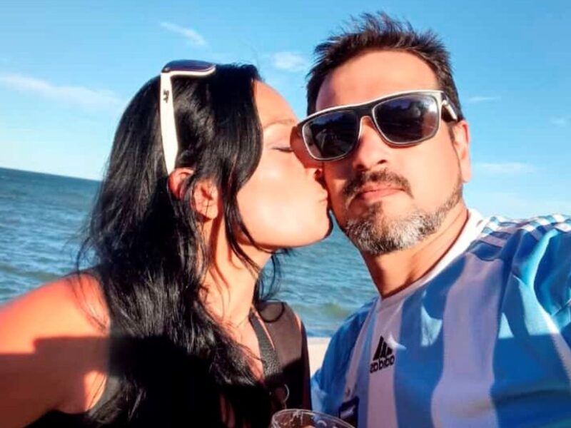 Yamila and Dardo, swingers who specialize in threesomes and “soft swapping,” posing for a selfie.