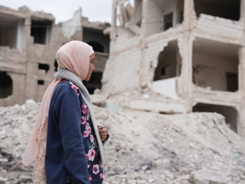 February 22, 2025, Damascus, Syria: A young girl looks at her house that was destroyed by airstrikes from Bashar al-Assad's regime.