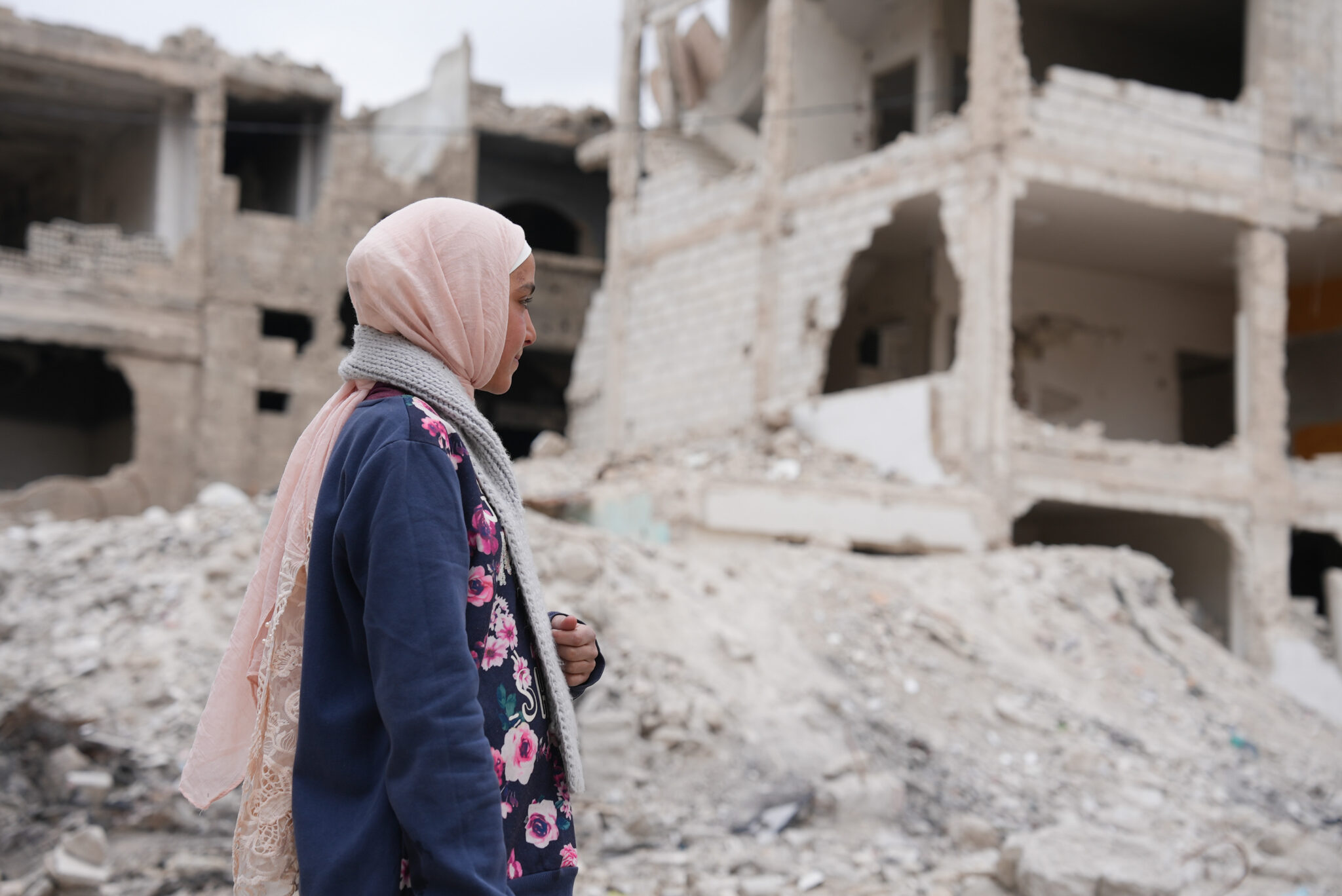 February 22, 2025, Damascus, Syria: A young girl looks at her house that was destroyed by airstrikes from Bashar al-Assad's regime.