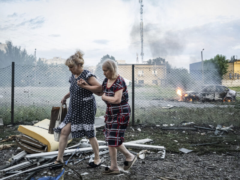 August 18, 2025, Kharkiv, Ukraine: Two ladies walk away from the carnage after five Russian deployed Shahed drones struck a residential building, killing 5 people