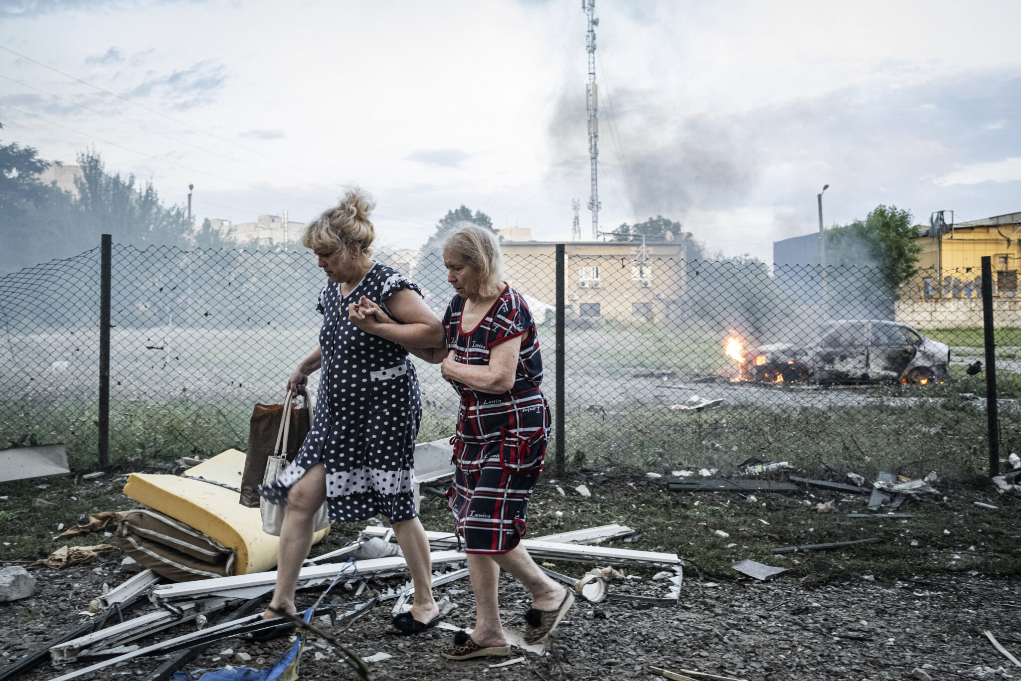 August 18, 2025, Kharkiv, Ukraine: Two ladies walk away from the carnage after five Russian deployed Shahed drones struck a residential building, killing 5 people