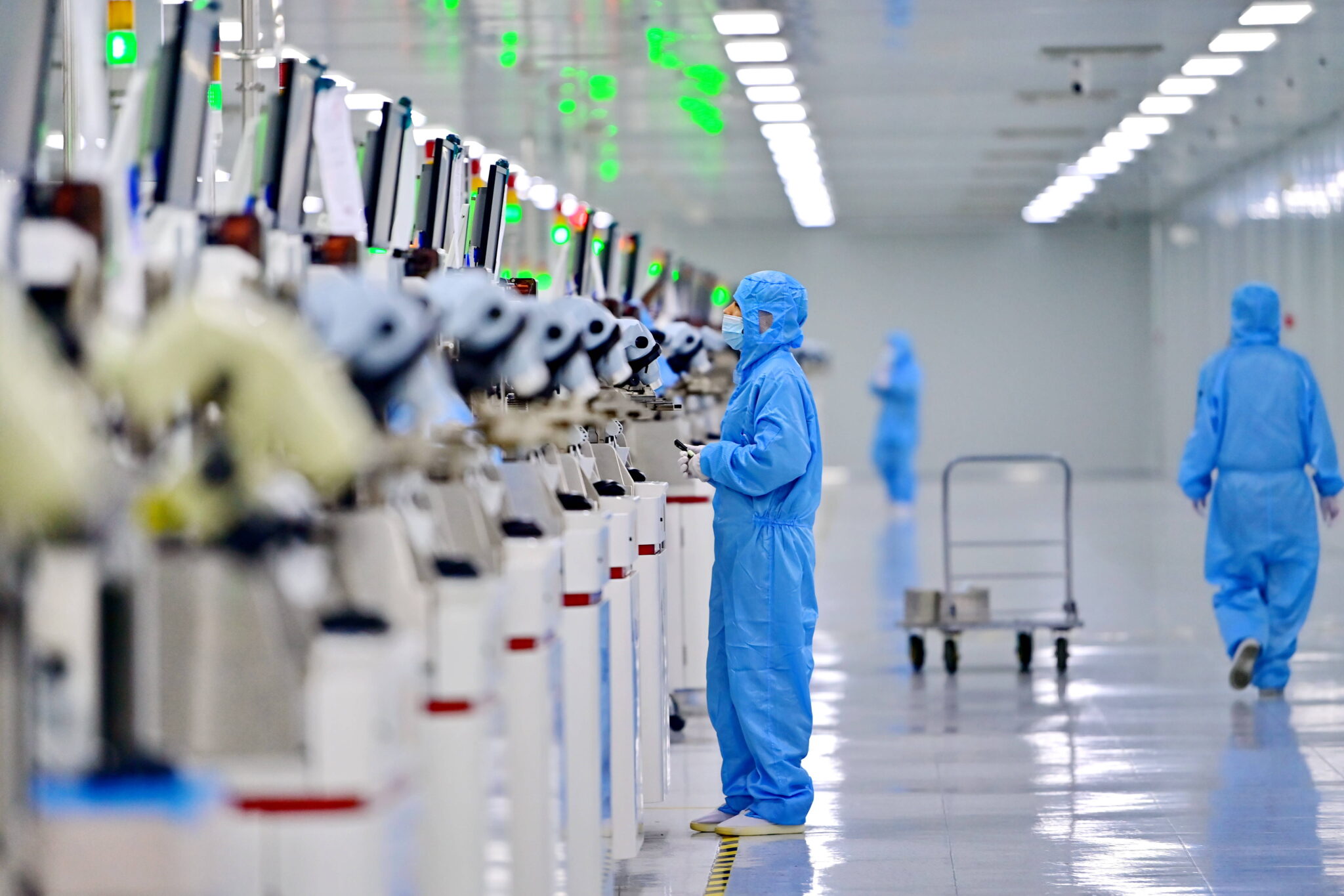 Employees work on a semiconductor production line at a science and technology enterprise in Jiujiang, Jiangxi Province of China.