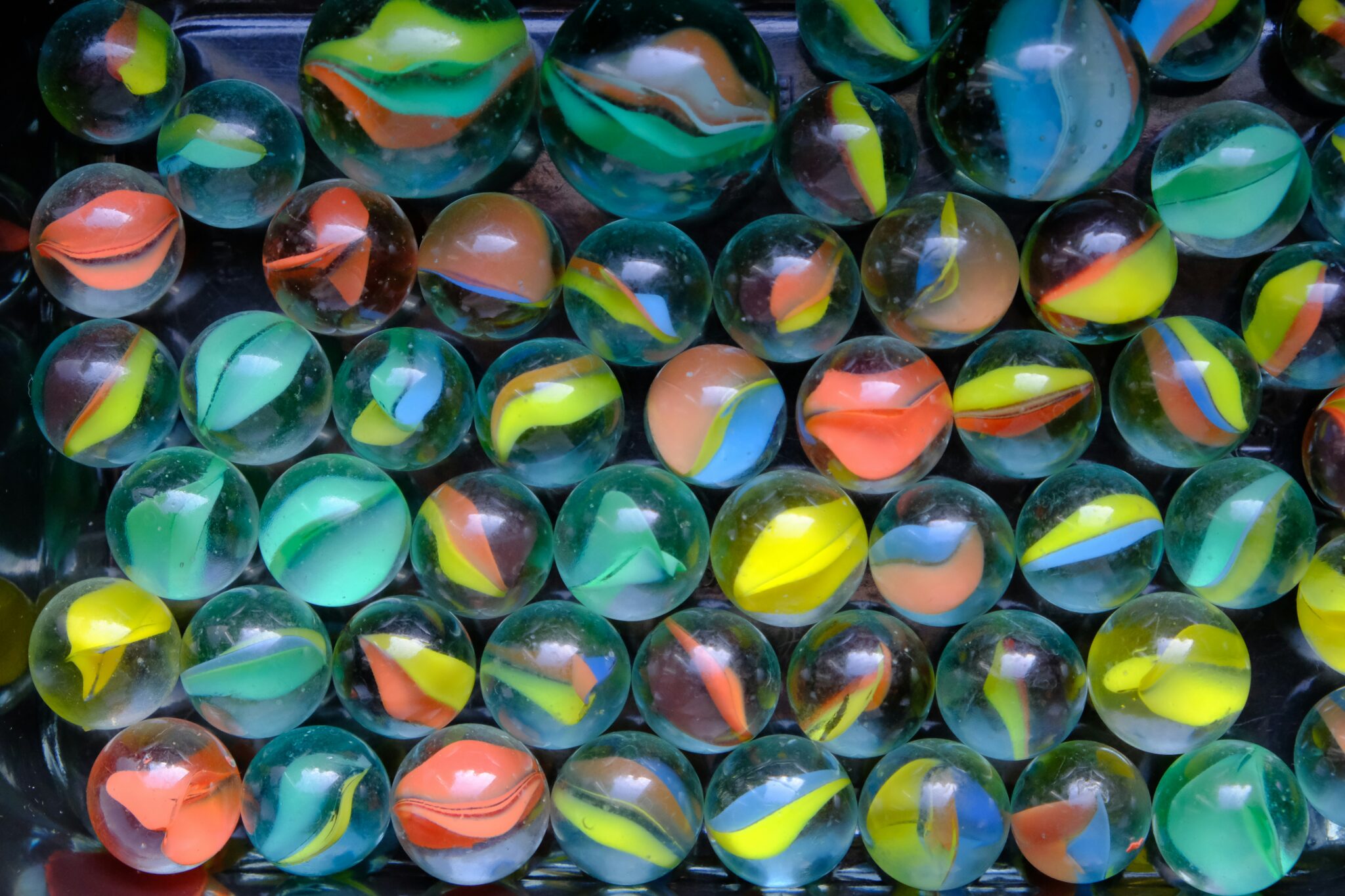 Colourful marbles sitting on a table