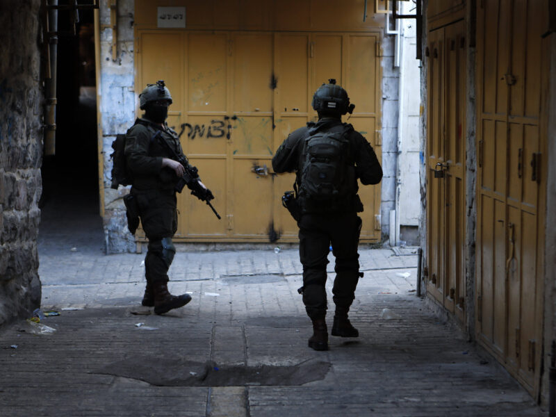 Israeli security forces stand guard as Israeli settlers tour in the Palestinian side of occupied West Bank on September 6, 2025.