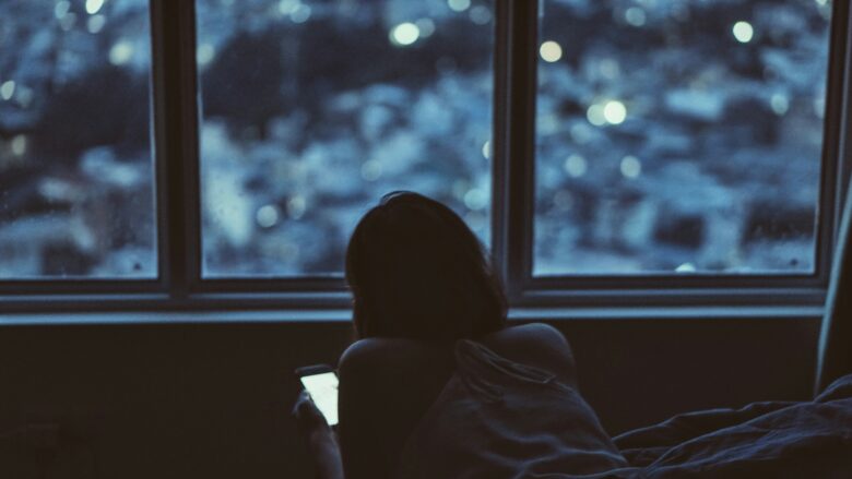 Woman on smartphone in the dark