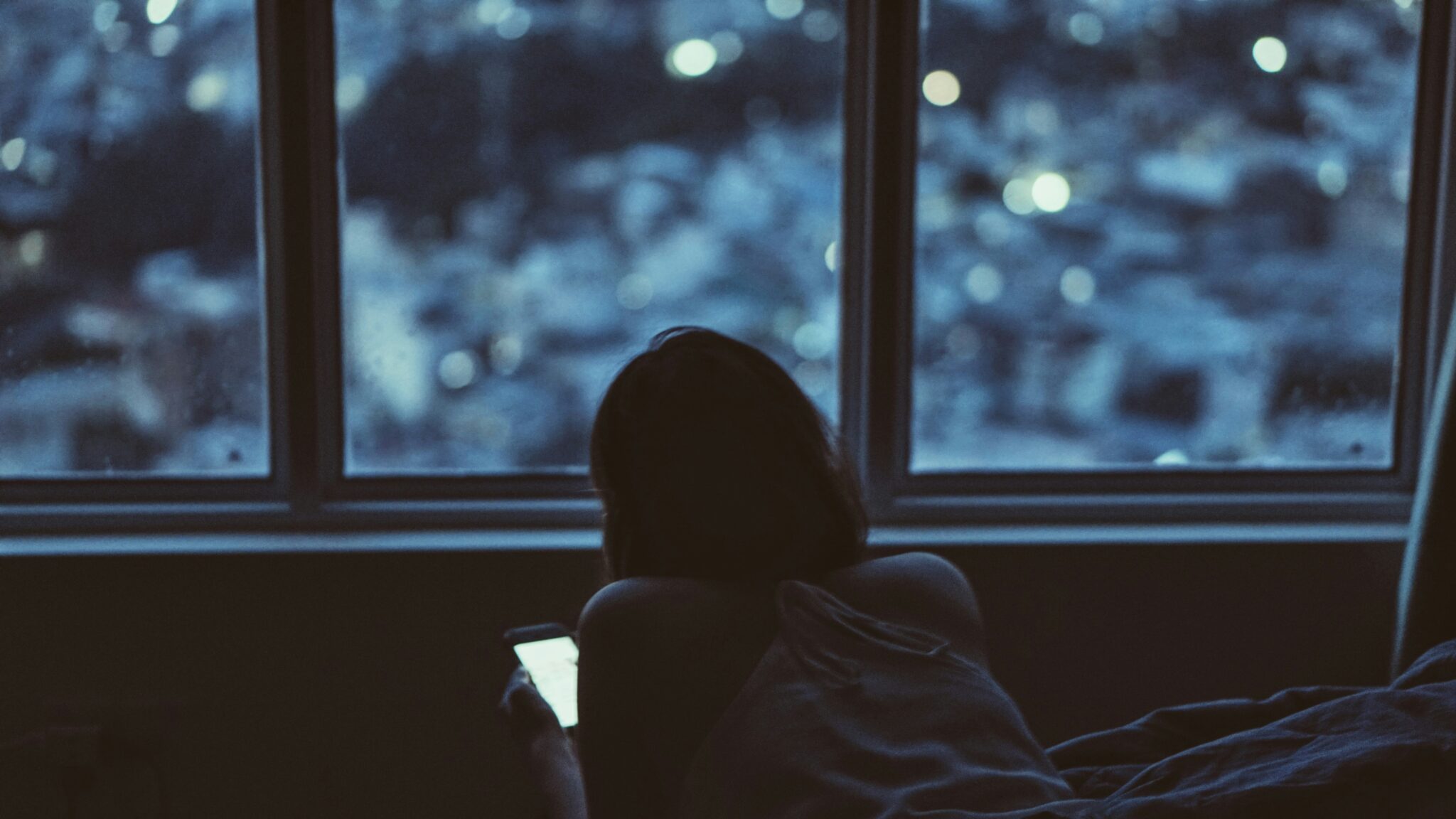 Woman on smartphone in the dark