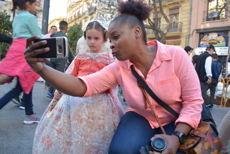 A woman takes a selfie with a young girl during the "Las Fallas" festival in Valencia, Spain.