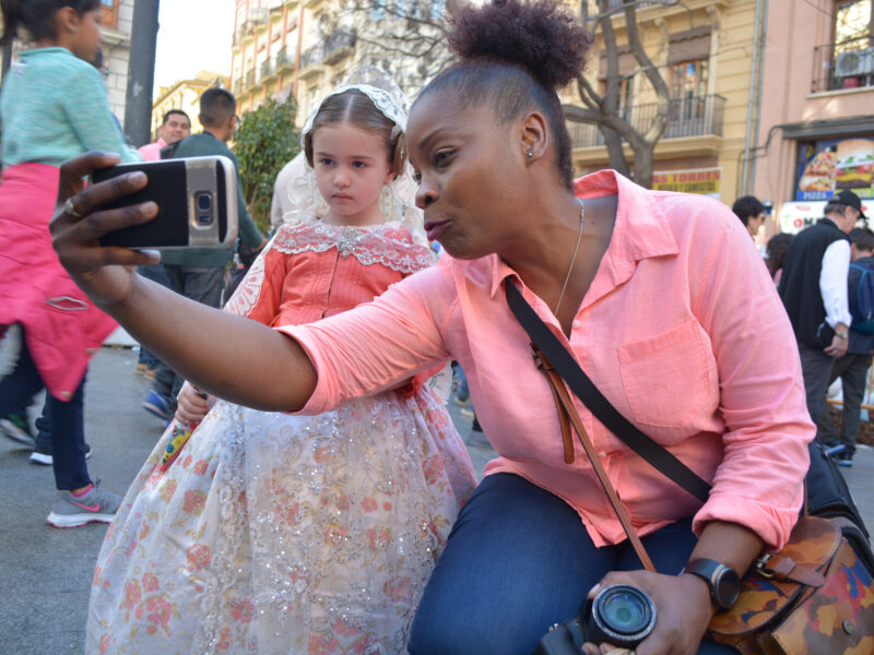 A woman takes a selfie with a young girl during the "Las Fallas" festival in Valencia, Spain.