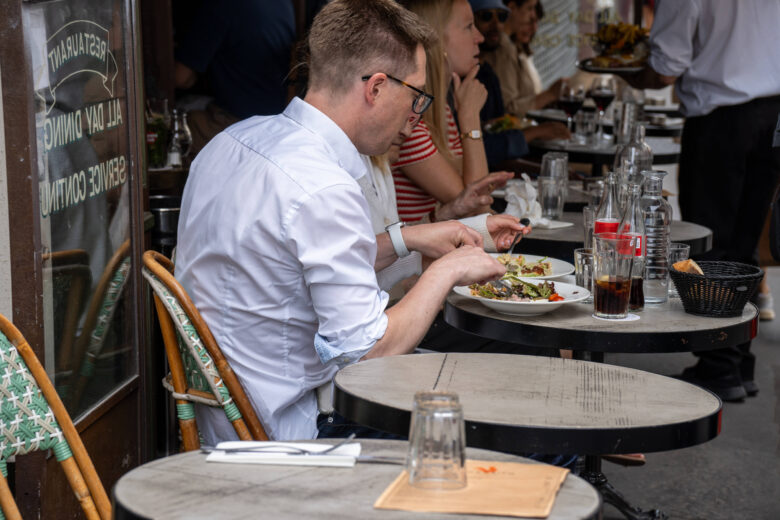 People eating on the terrace of a restaurant in Paris.