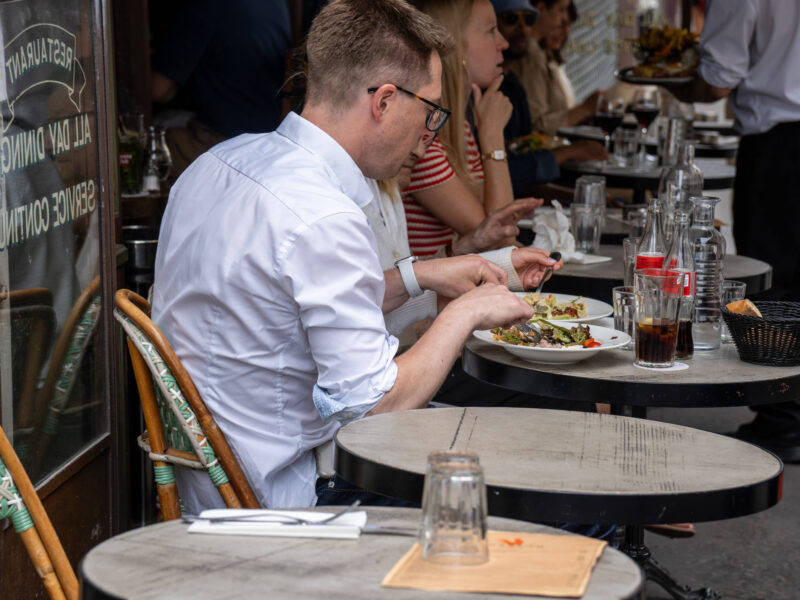People eating on the terrace of a restaurant in Paris.