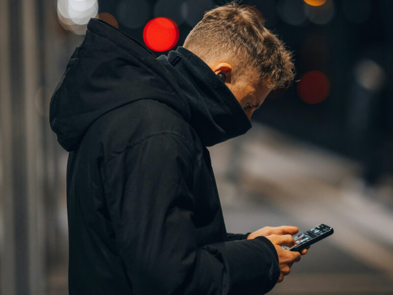Photo of a man looking at his phone.