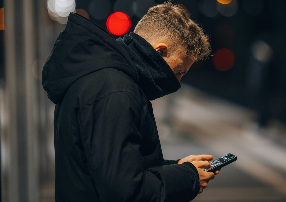 Photo of a man looking at his phone.