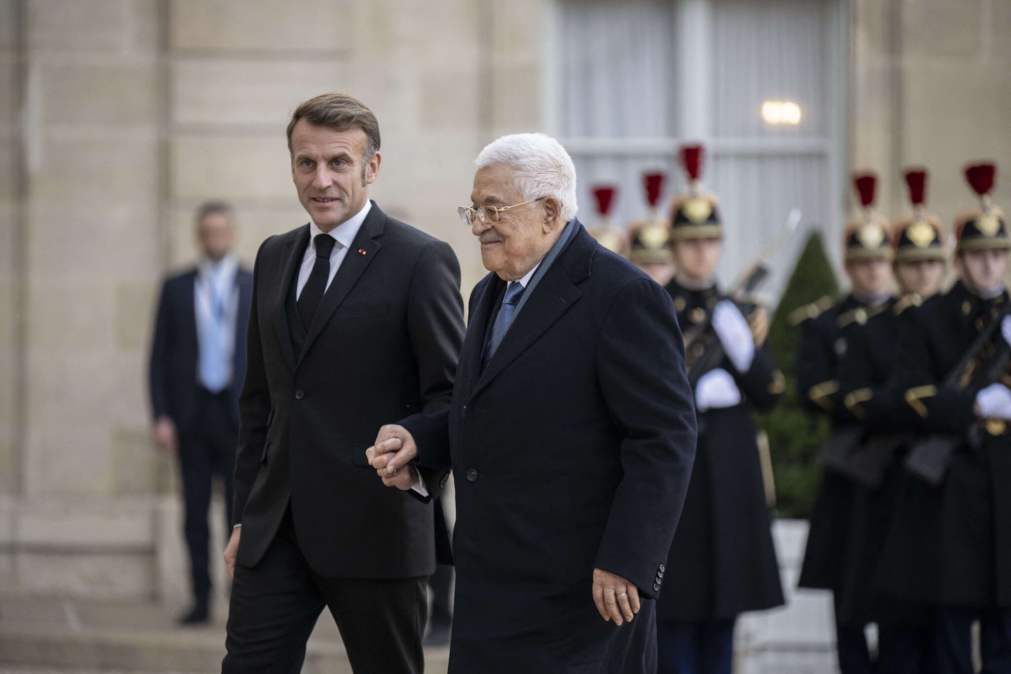 French President Emmanuel Macron welcomes Palestinian president Mahmud Abbas at the Elysee Presidential Palace in Paris on November 11, 2025.