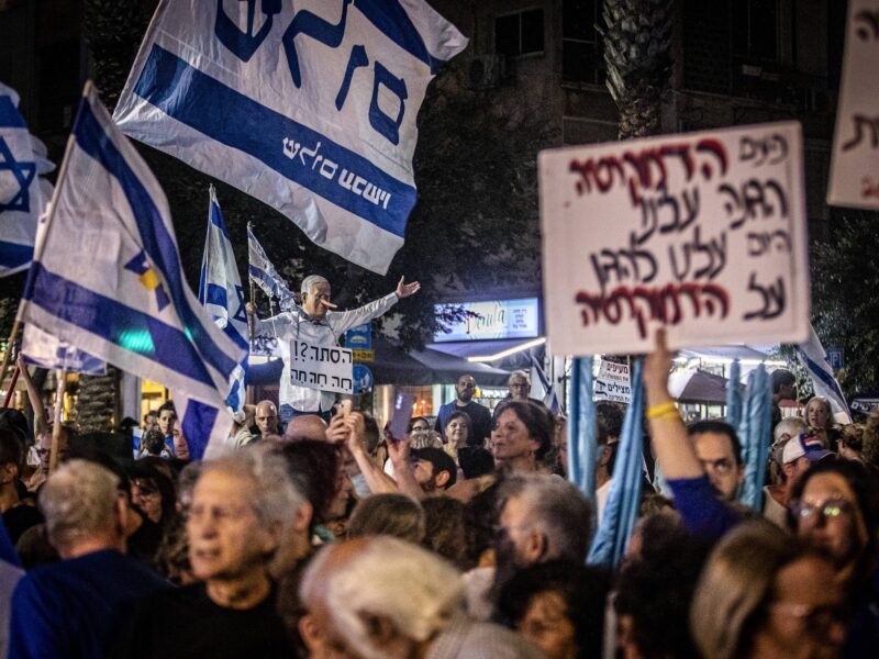 Protestors hold signs during the Rabin memorial rally on November 1, 2025, Tel Aviv, Israel.