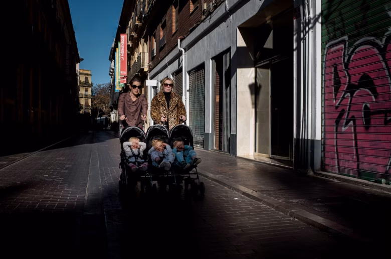 two women pushing a stroller