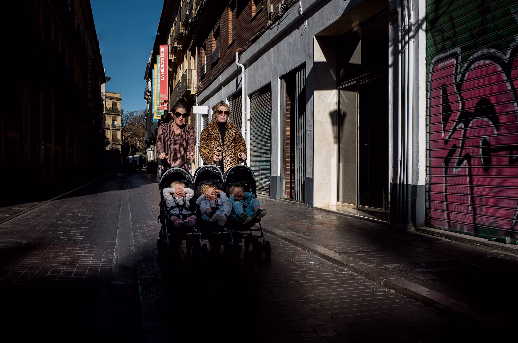 two women pushing a stroller