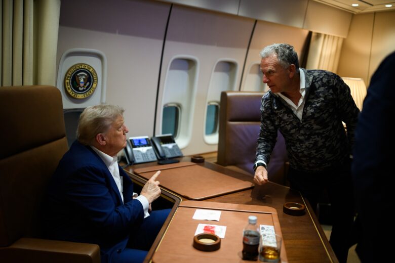 President Donald Trump talks to Middle East Envoy Steve Witkoff on board Air Force One.