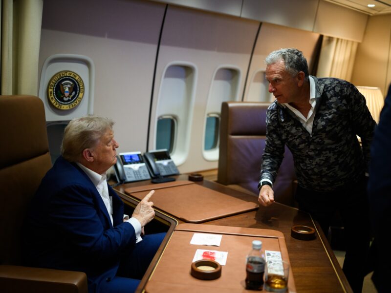 President Donald Trump talks to Middle East Envoy Steve Witkoff on board Air Force One.