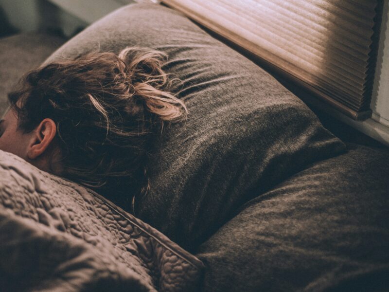 Woman sleeping under blankets.