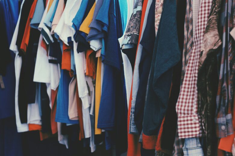 Clothes hanging on a rail.