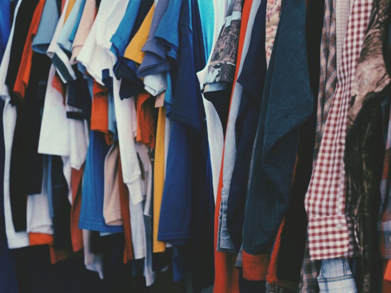 Clothes hanging on a rail.