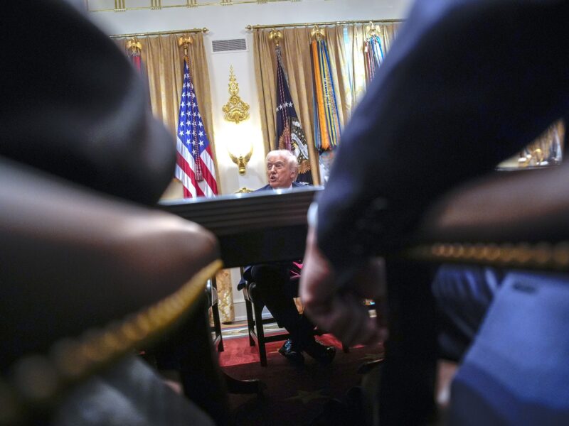 Donald Trump answers reporters questions at a meeting with his Cabinet in the White House in Washington on December 2, 2025