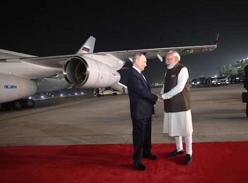 Russian President Vladimir Putin, left, is embraced by Indian Prime Minister Narendra Modi, right, on arrival to Indira Gandhi International Airport, December 4, 2025 in New Delhi, India.